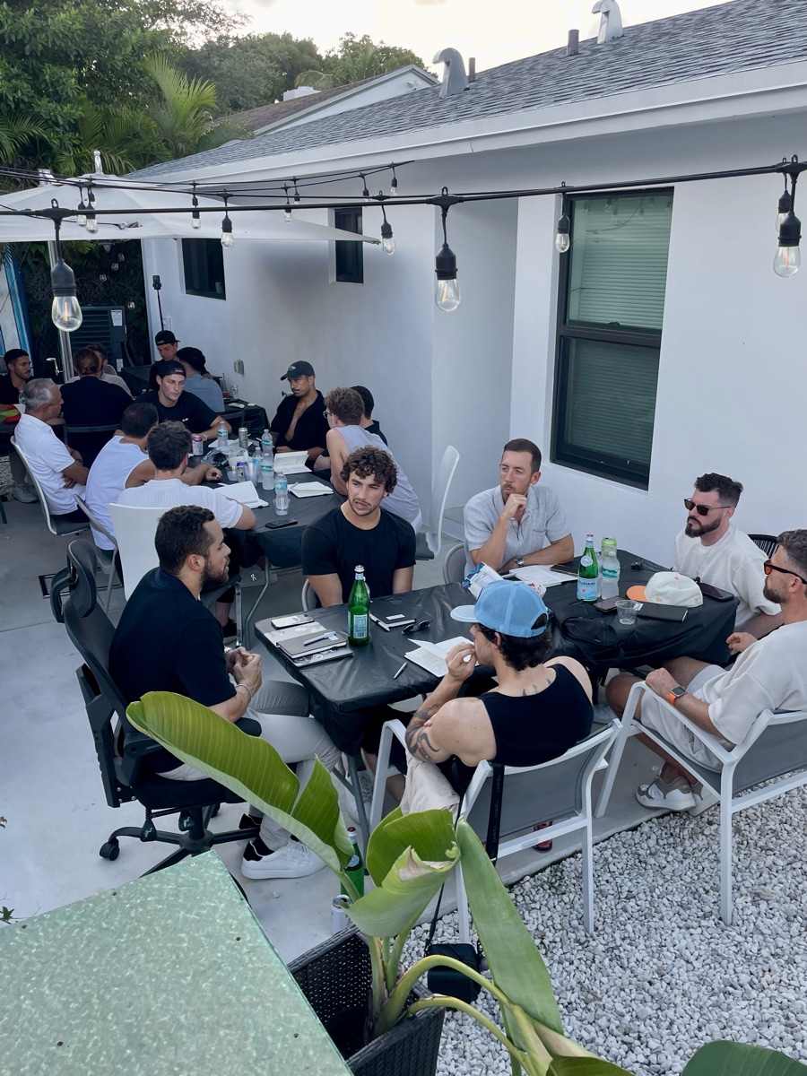 Entrepreneurs at tables in the backyard at the first Miami Founders Backyard BBQ